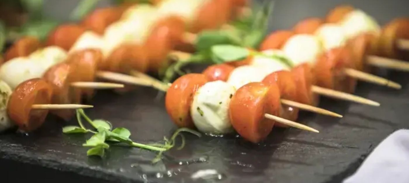 Tomato and mozzarella canapés on a slate