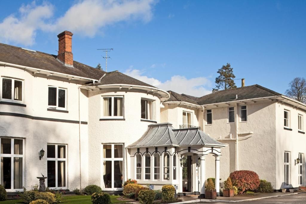 The front of Brandon Hall Hotel and Spa with its glazed porch and bay windows