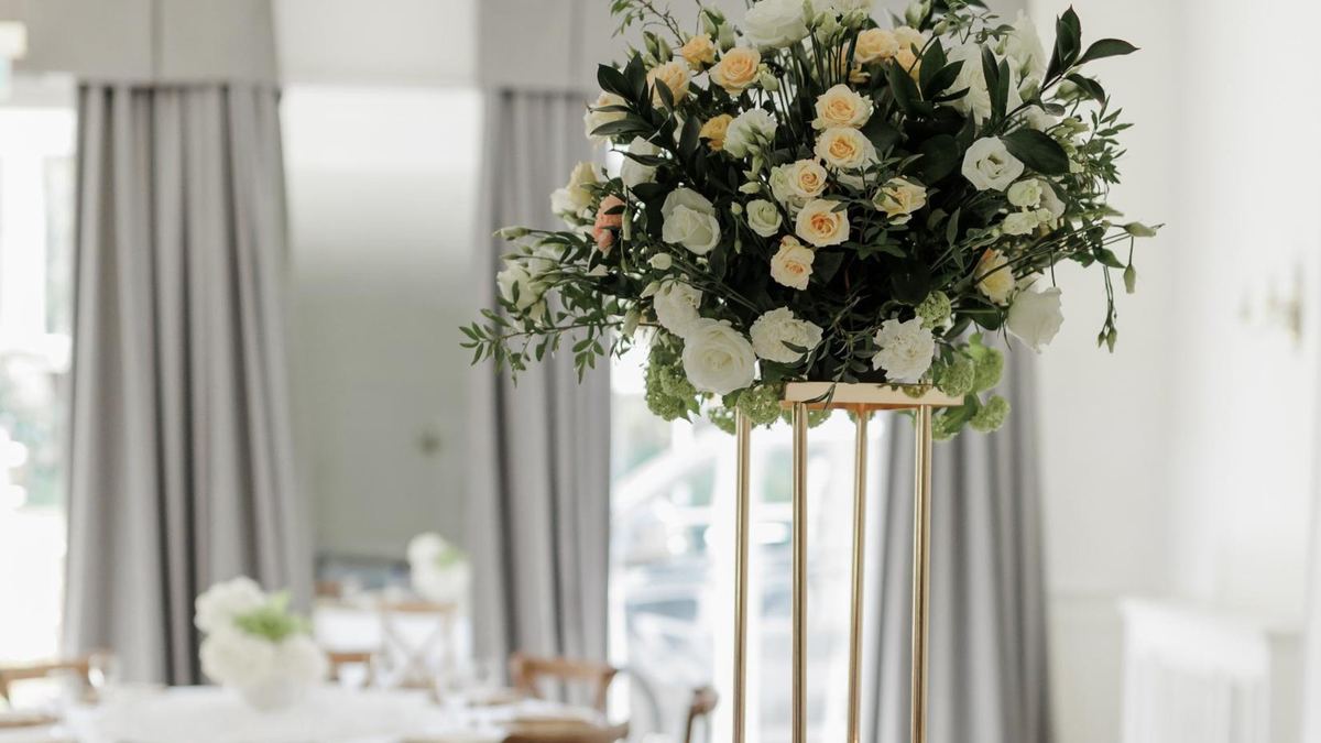 A tall floral centrepiece by the window