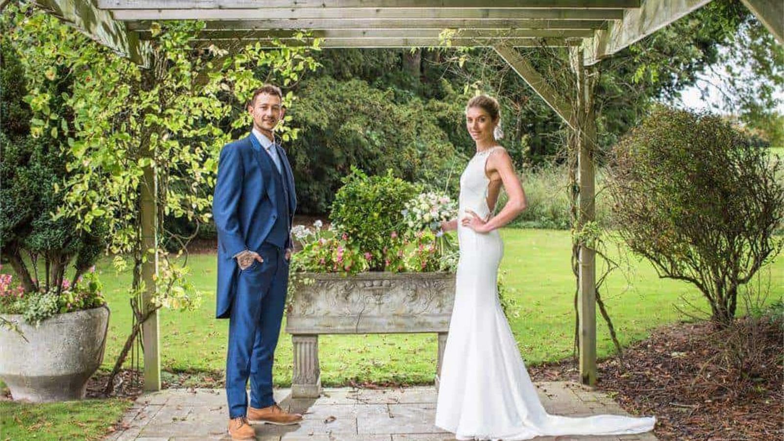 A couple under a pergola in the garden