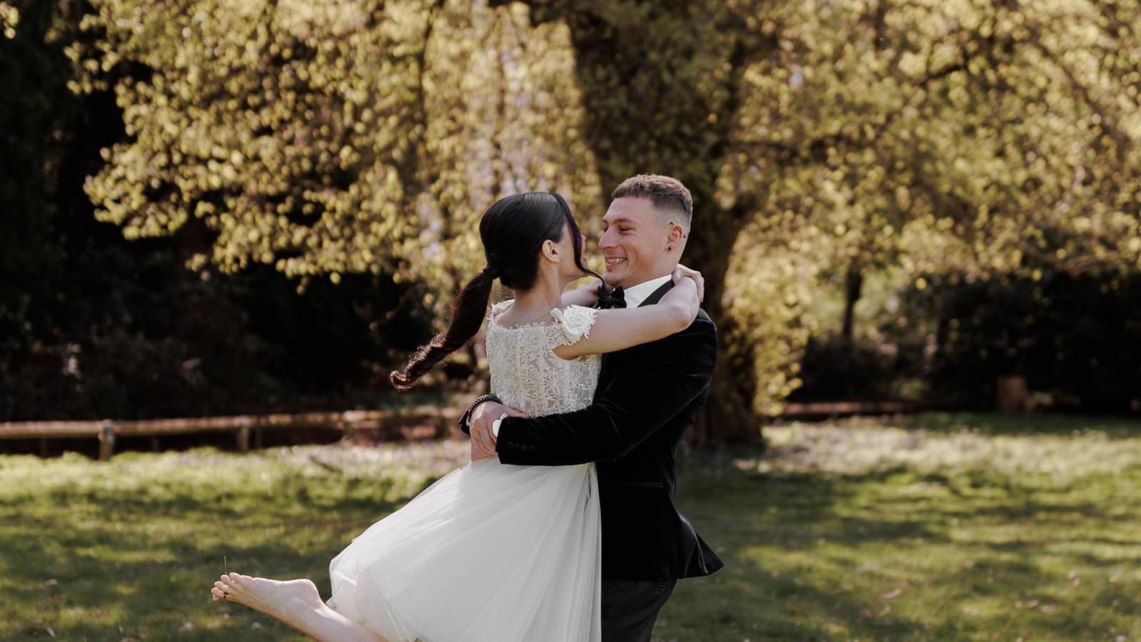 A couple embracing under the trees at golden hour