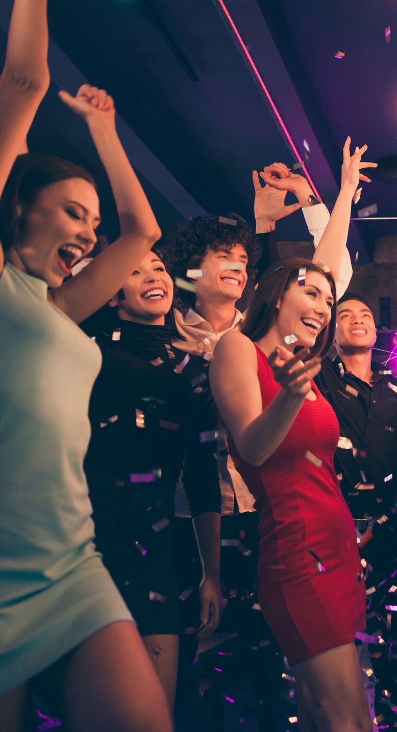 Friends dancing under festive lights