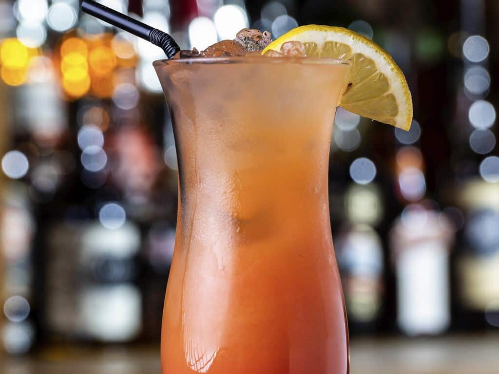 Refreshing tropical cocktail with lemon wedge and ice, perfect for relaxing at Brandon Hall Hotel & Spa.