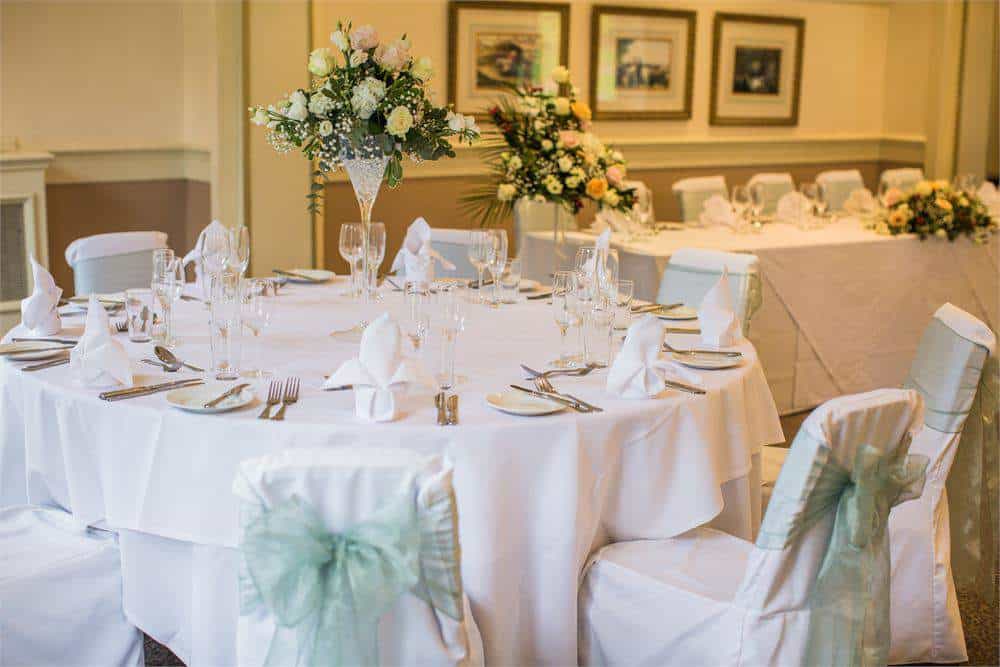 Luxurious wedding reception setup at Brandon Hall Hotel & Spa featuring decorated tables and floral arrangements.